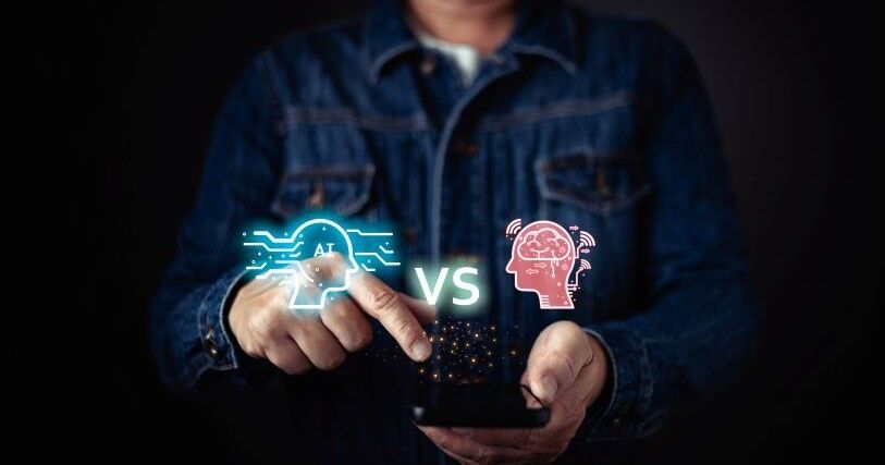 Against a black background, a man holds a device with glowing pinpoints of light. Head icons, one reading 'AI' and the other showing a brain, symbolize the comparison of AI and human assistance