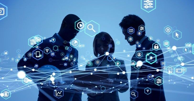 3 figures, 2 men and one woman, stand against a blue background with technology icons swirling around them
